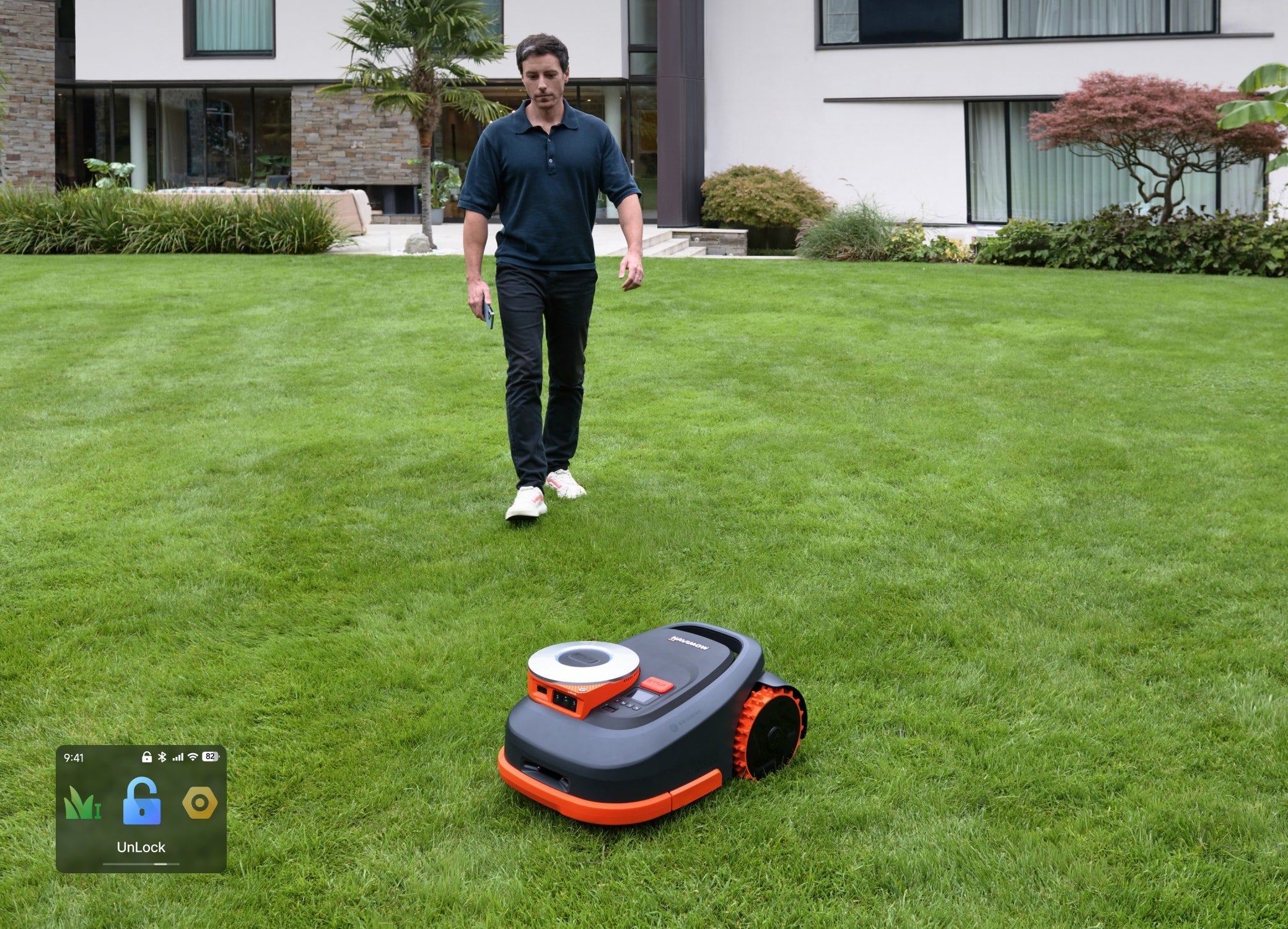 Navimow i110N robot lawn mower mows the man's green grass.