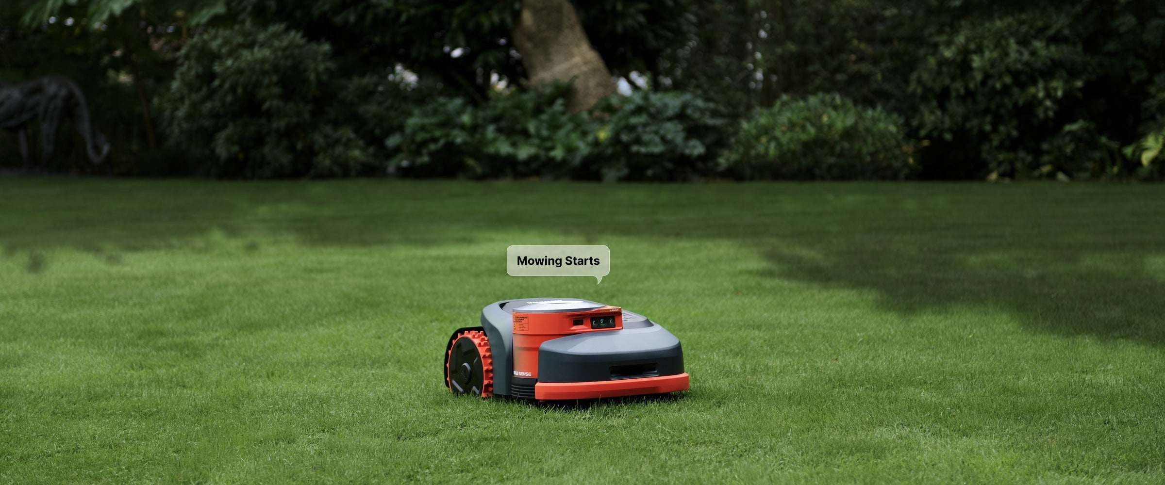A Navimow i110E robot lawn mower starts mowing green grass.