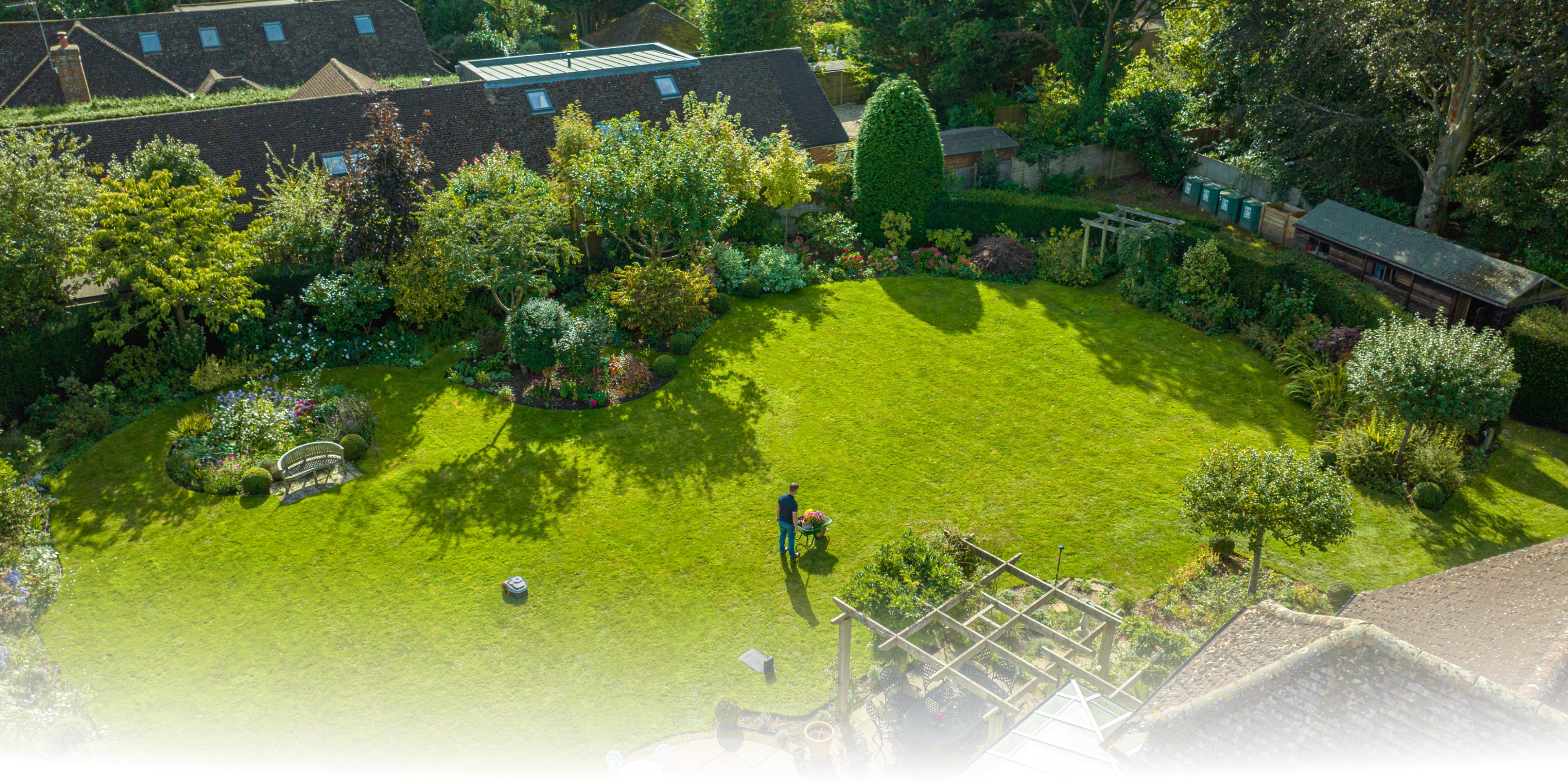 Segway Navimow i105E robot lawn mower in a large garden.