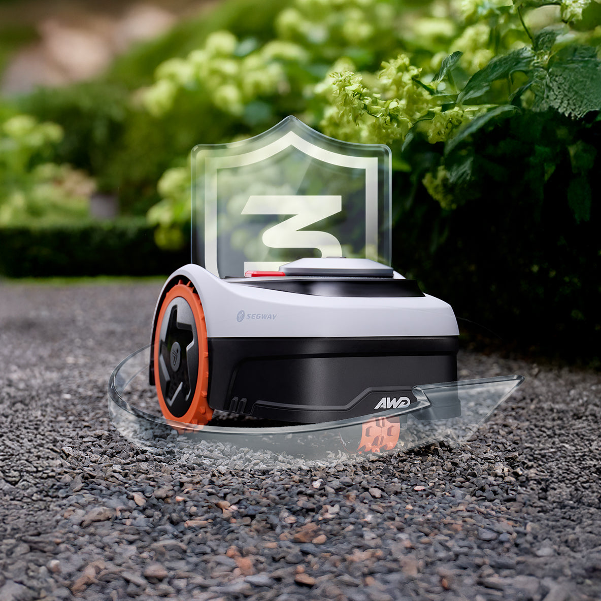 Segway Navimow i110N AWD robot lawn mower sits on gravel.