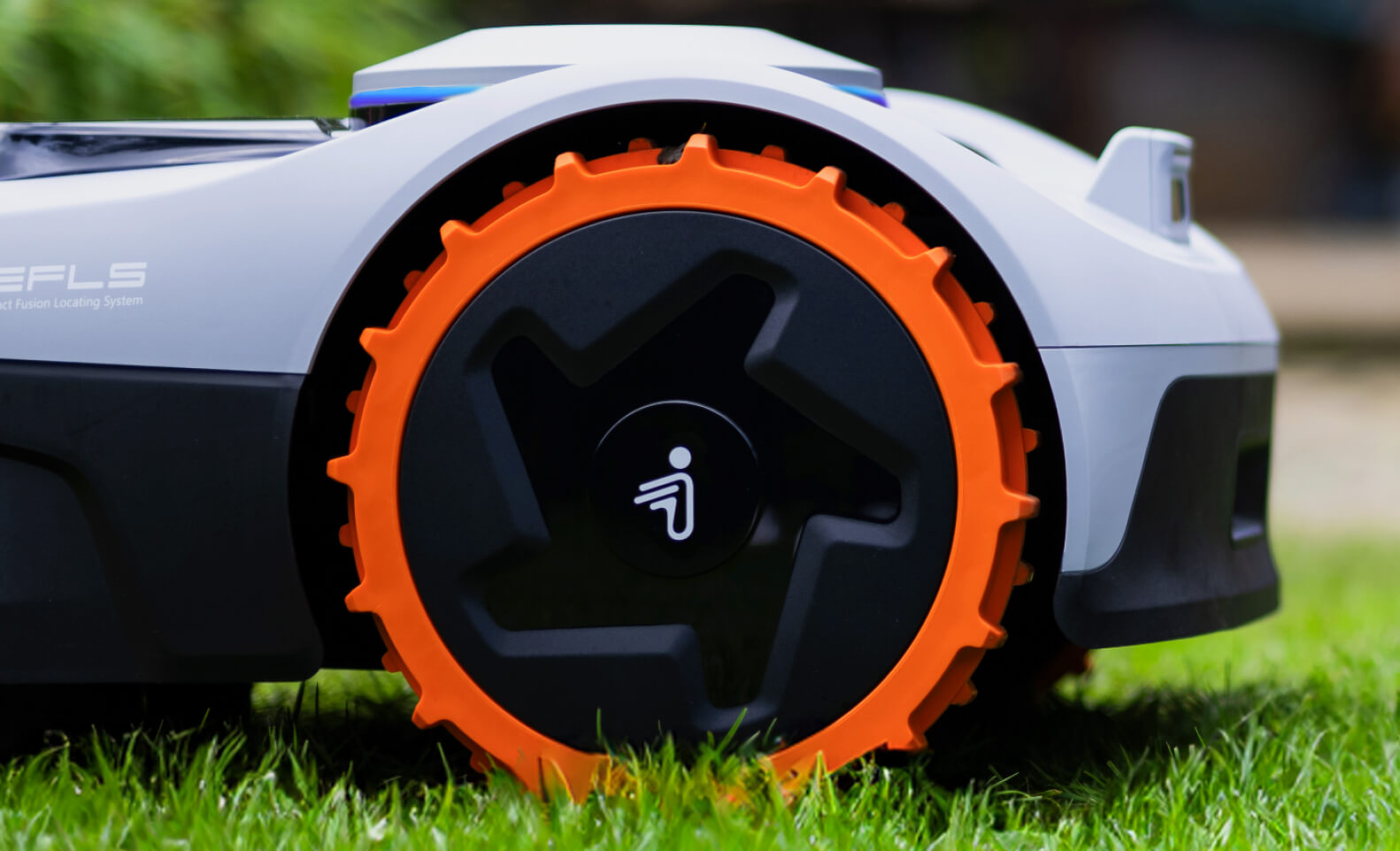 Segway Navimow H series robot lawn mower with orange wheels.