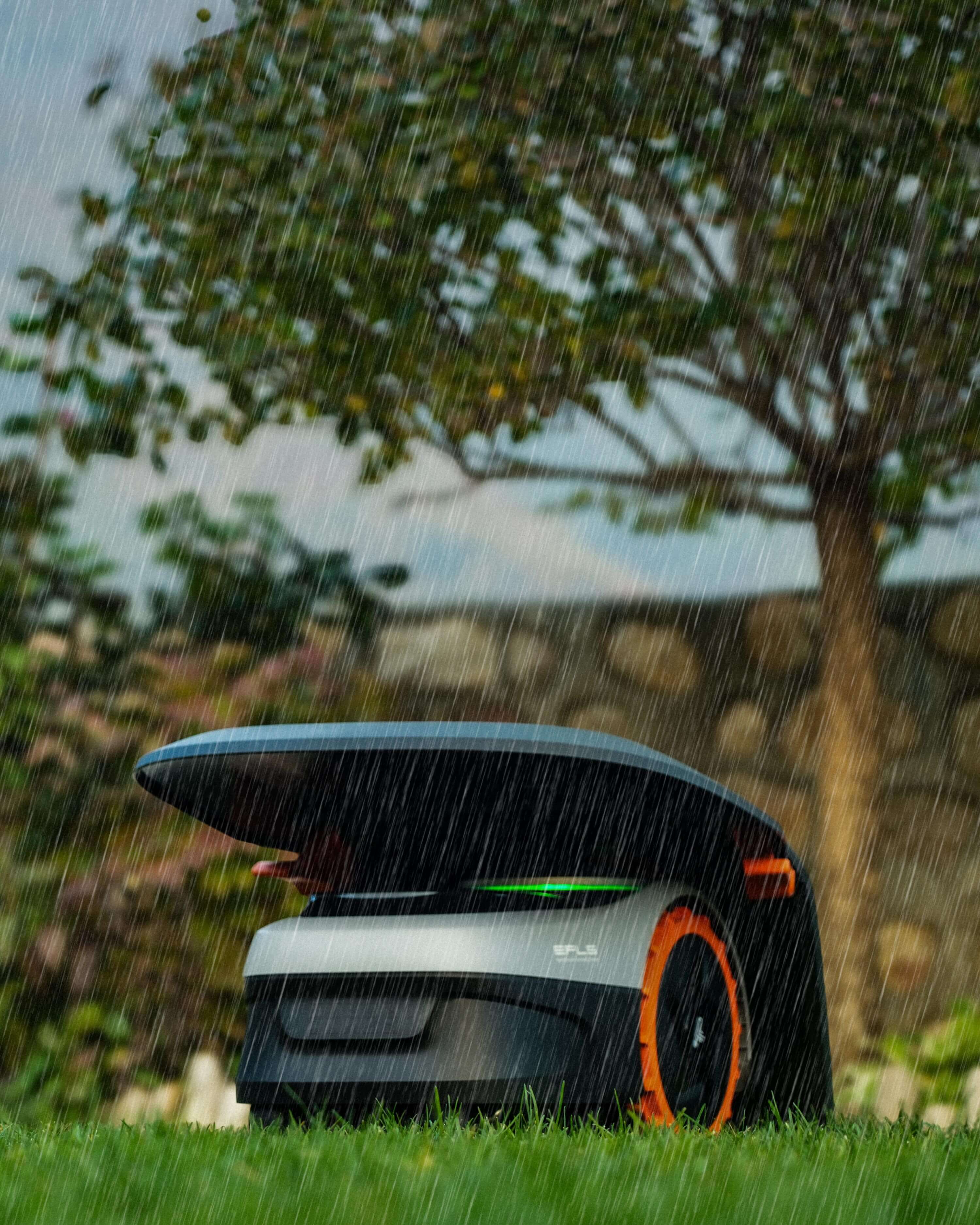Navimow i110N robot lawn mower is working in the rain.