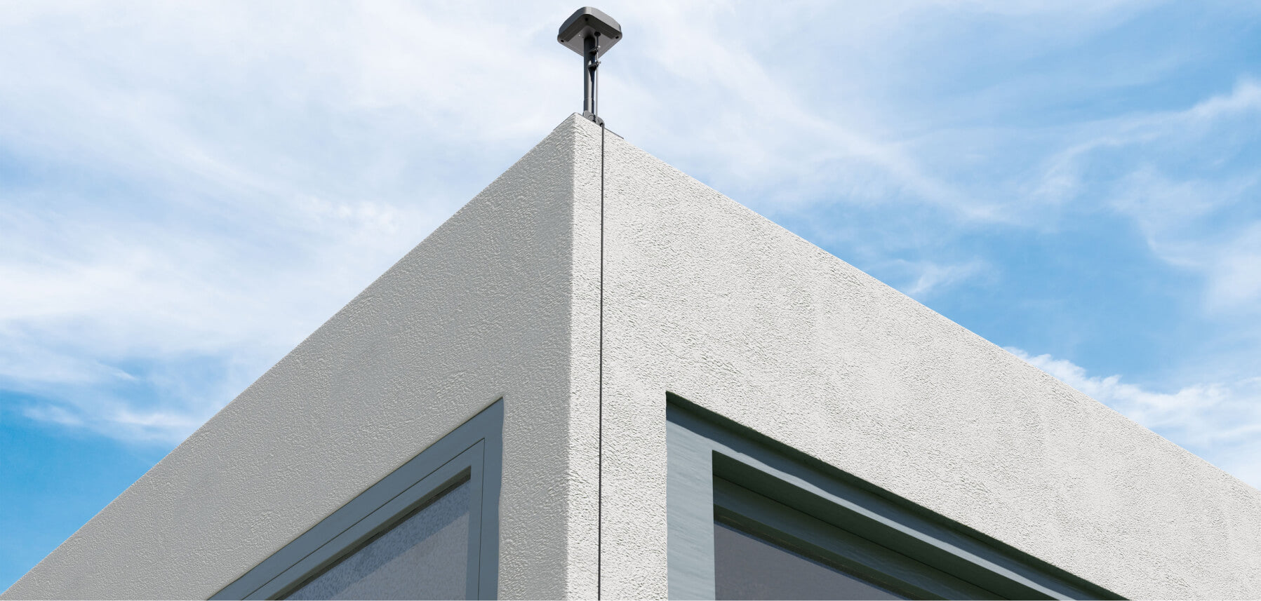 Segway Navimow i105E robot lawn mower antenna on building corner.