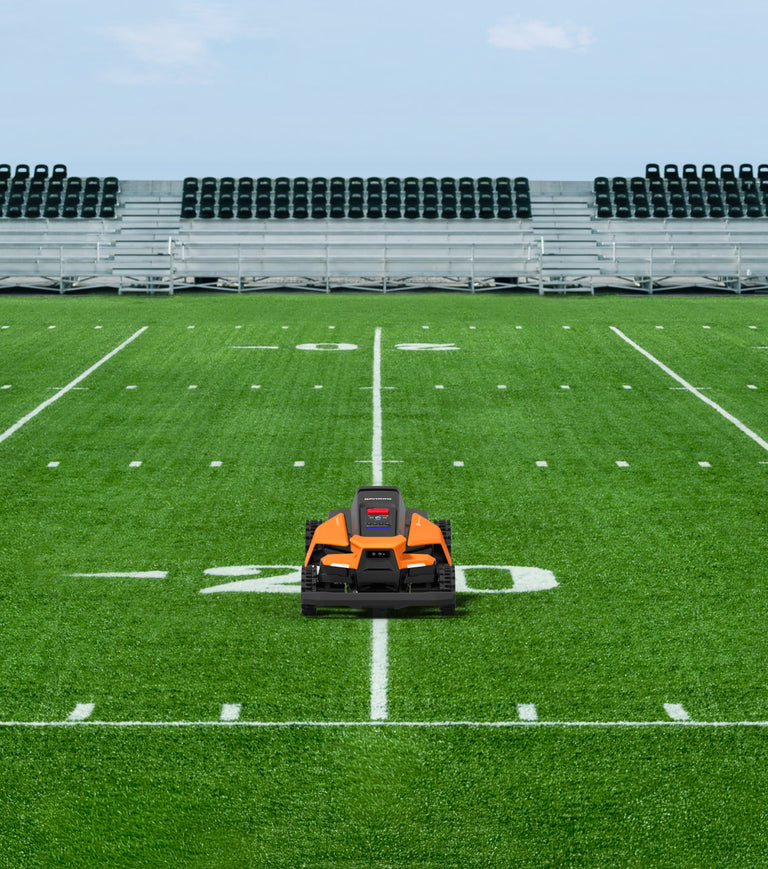 Navimow i110N robot lawn mower on the green football field.
