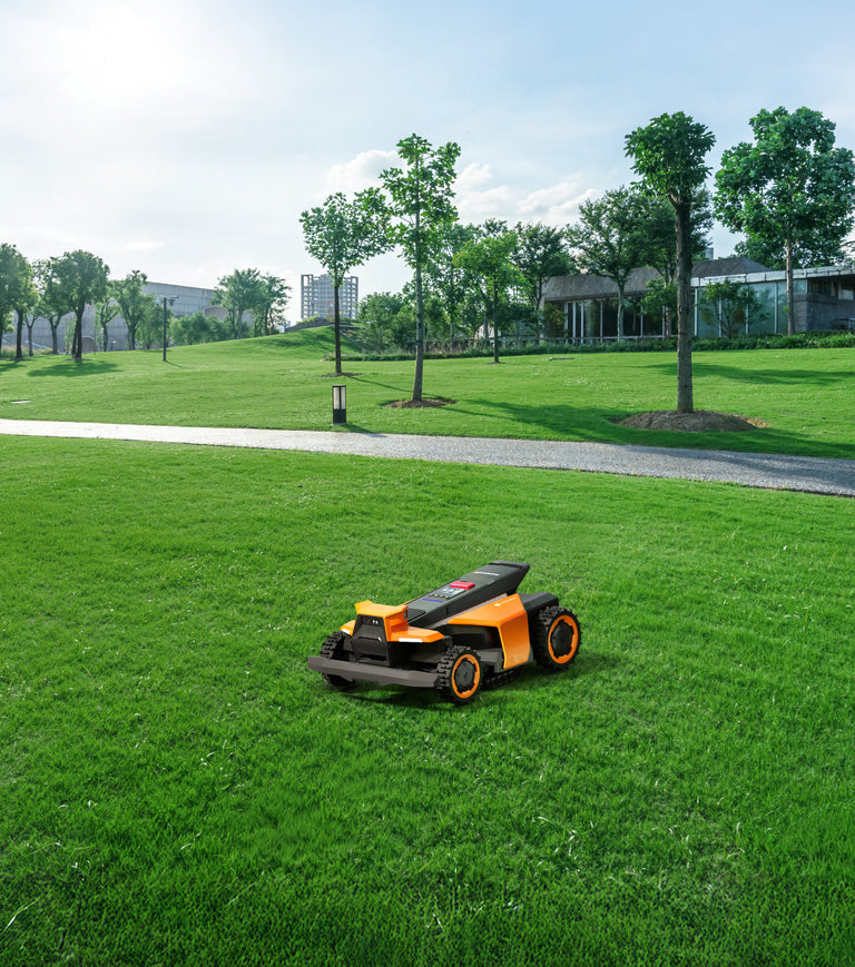 Segway Navimow i105E robot lawn mower on a green field.