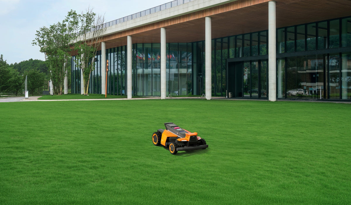 Navimow i110N robot lawn mower on a flat green lawn.