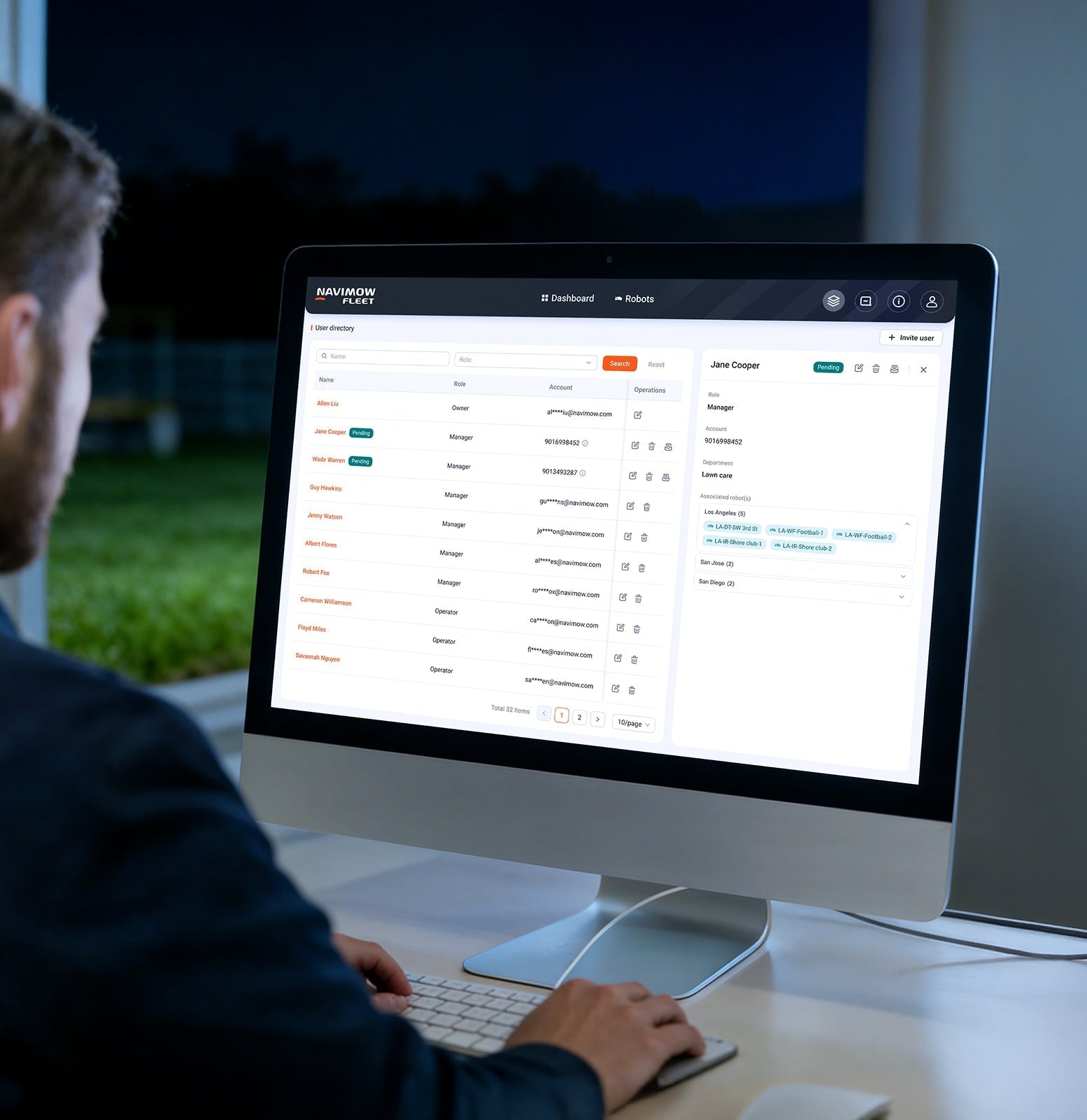 A man views the Navimow Fleet robot lawn mower dashboard.