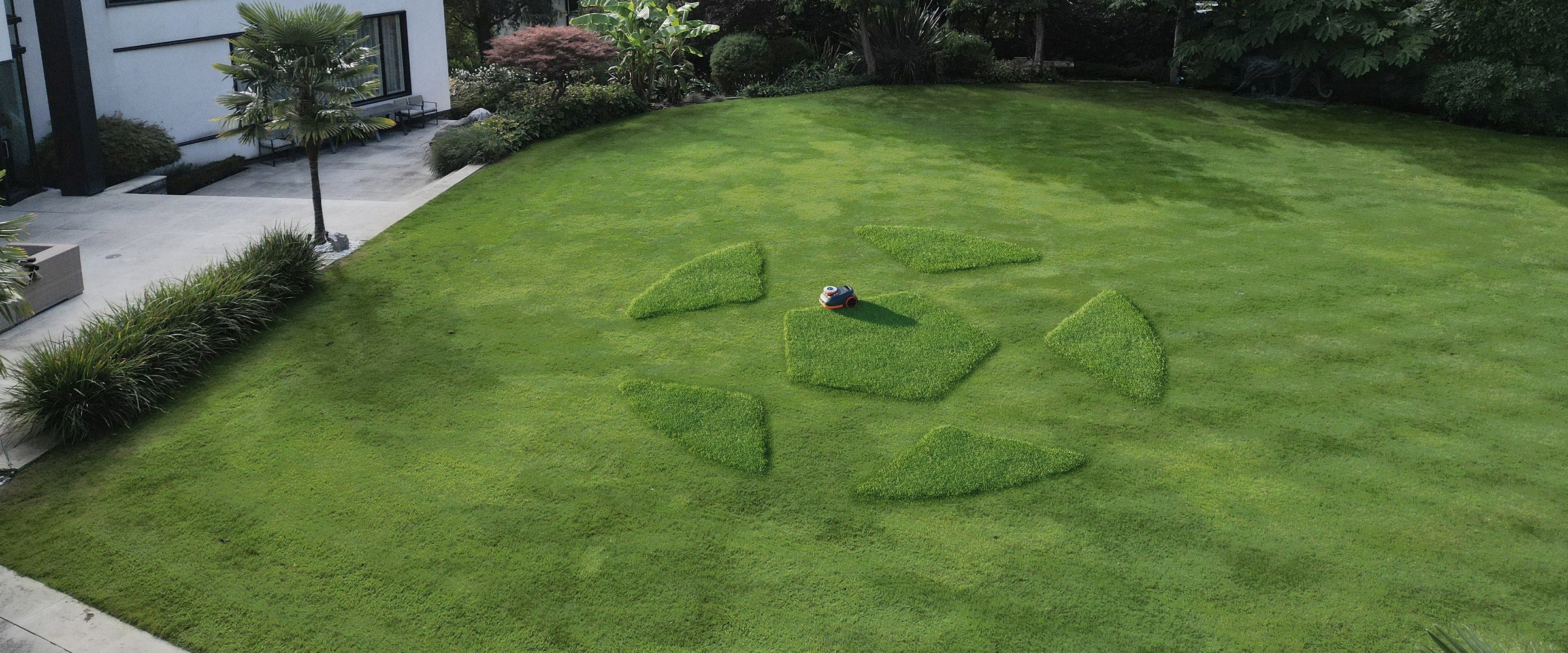 Navimow i110E robot lawn mower mows a large soccer ball.
