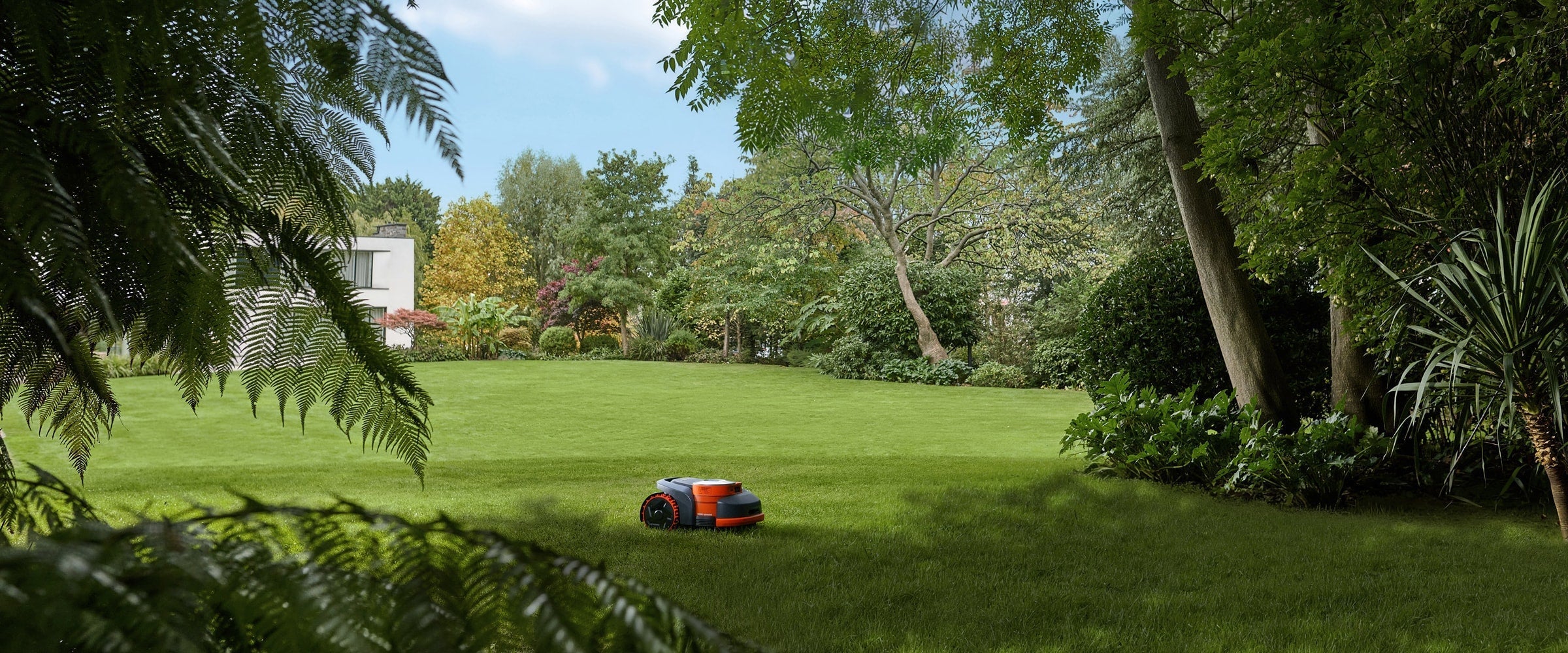 Navimow i110N robot lawn mower mows a large garden lawn.