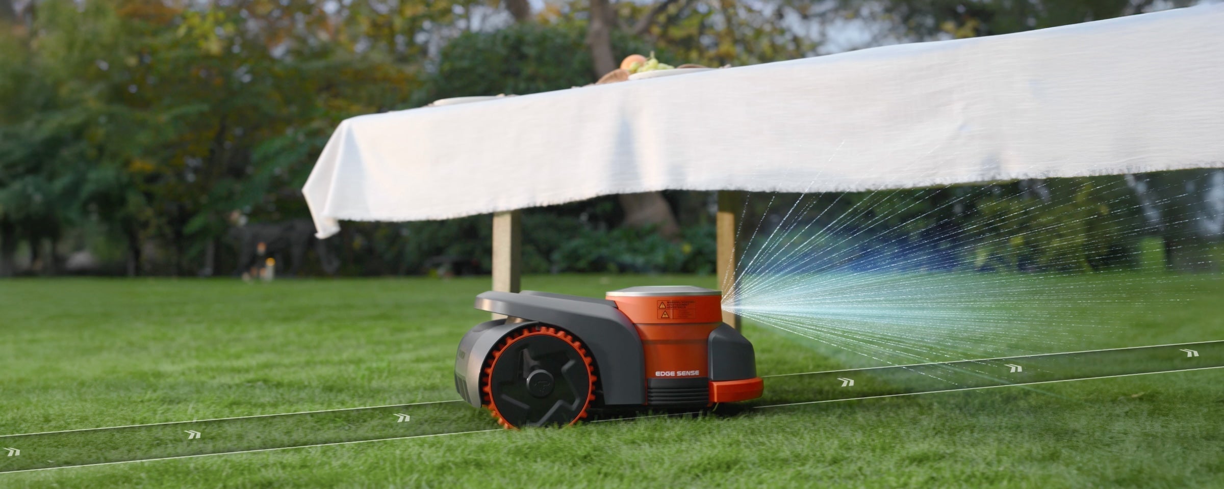 Navimow i Series robot lawn mower mows under a table.