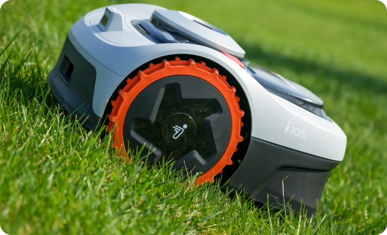Navimow i105 robot lawn mower stands on the green grass.