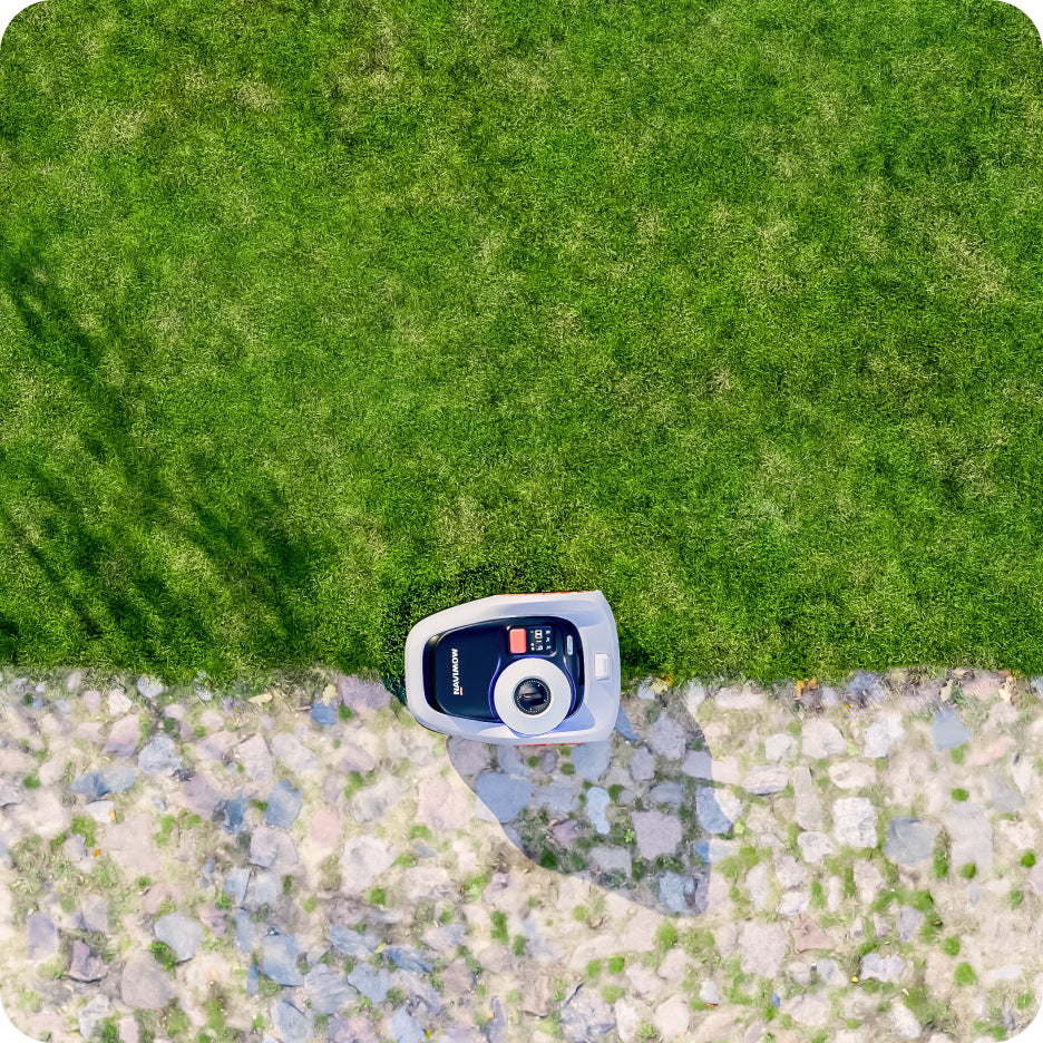 Navimow i105E robot lawn mower on a lush green lawn.