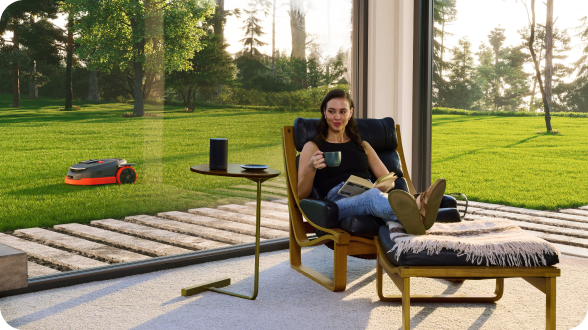 Navimow i110N robot lawn mower mows while the woman relaxes.