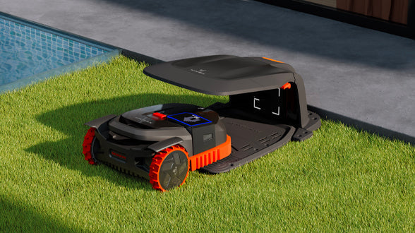 Navimow i105E robot lawn mower charging on a green lawn.