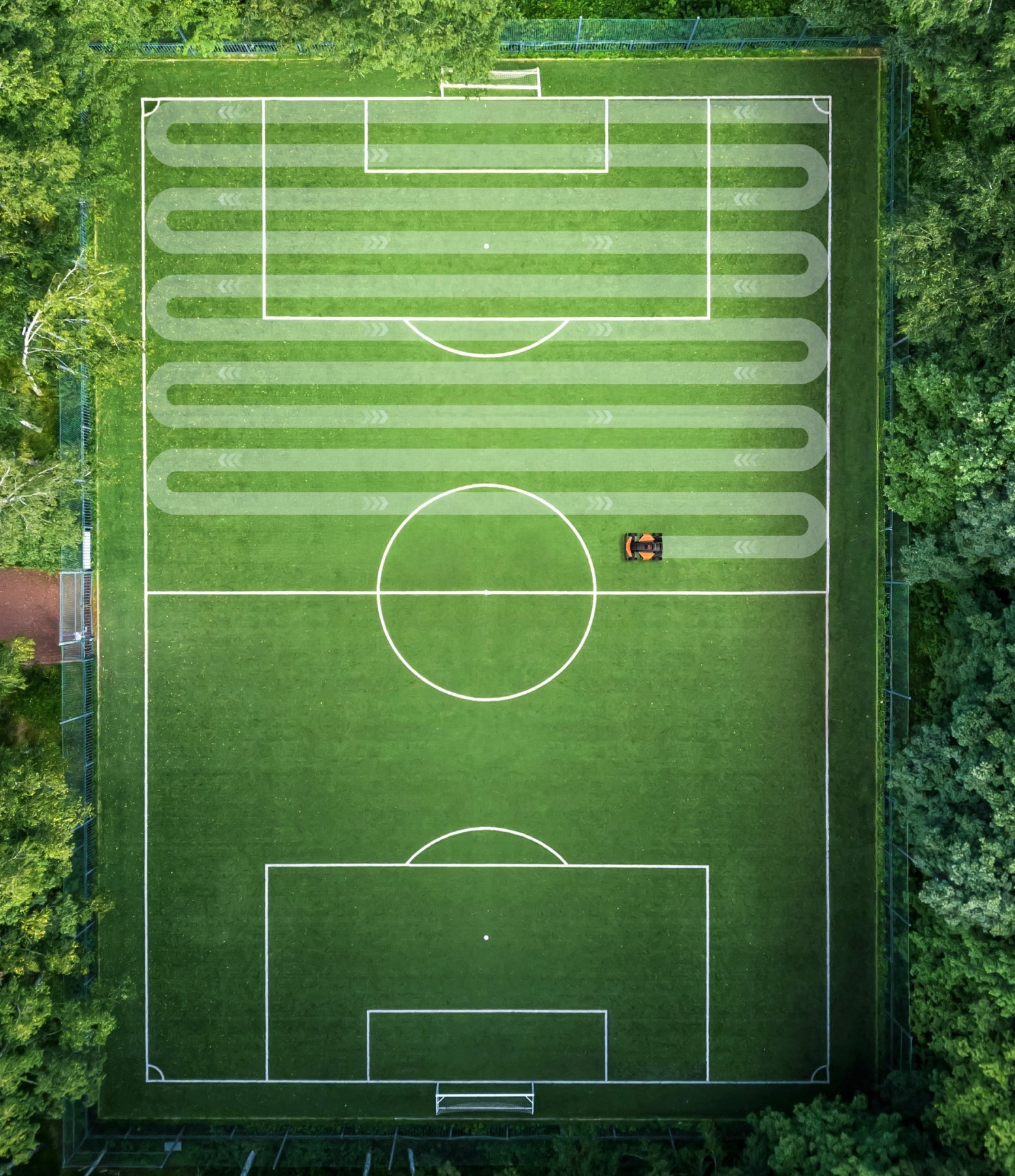 Segway Navimow i105E robot lawn mower mows a soccer field.