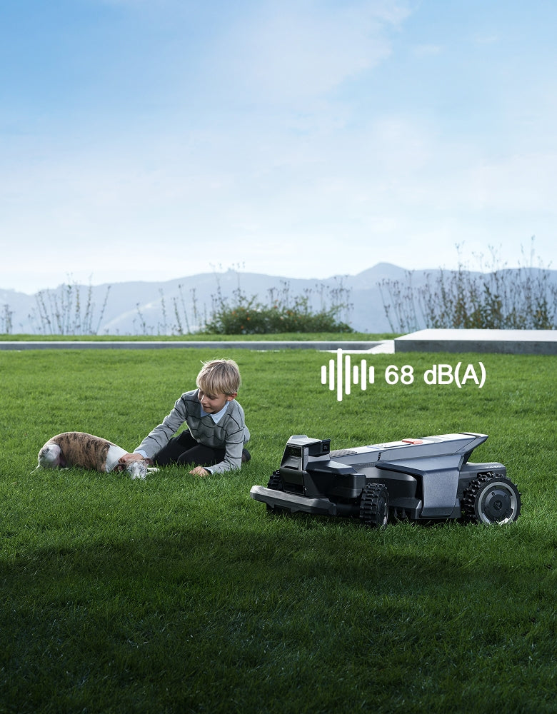 Segway Navimow i110N robot lawn mower beside boy and dog.