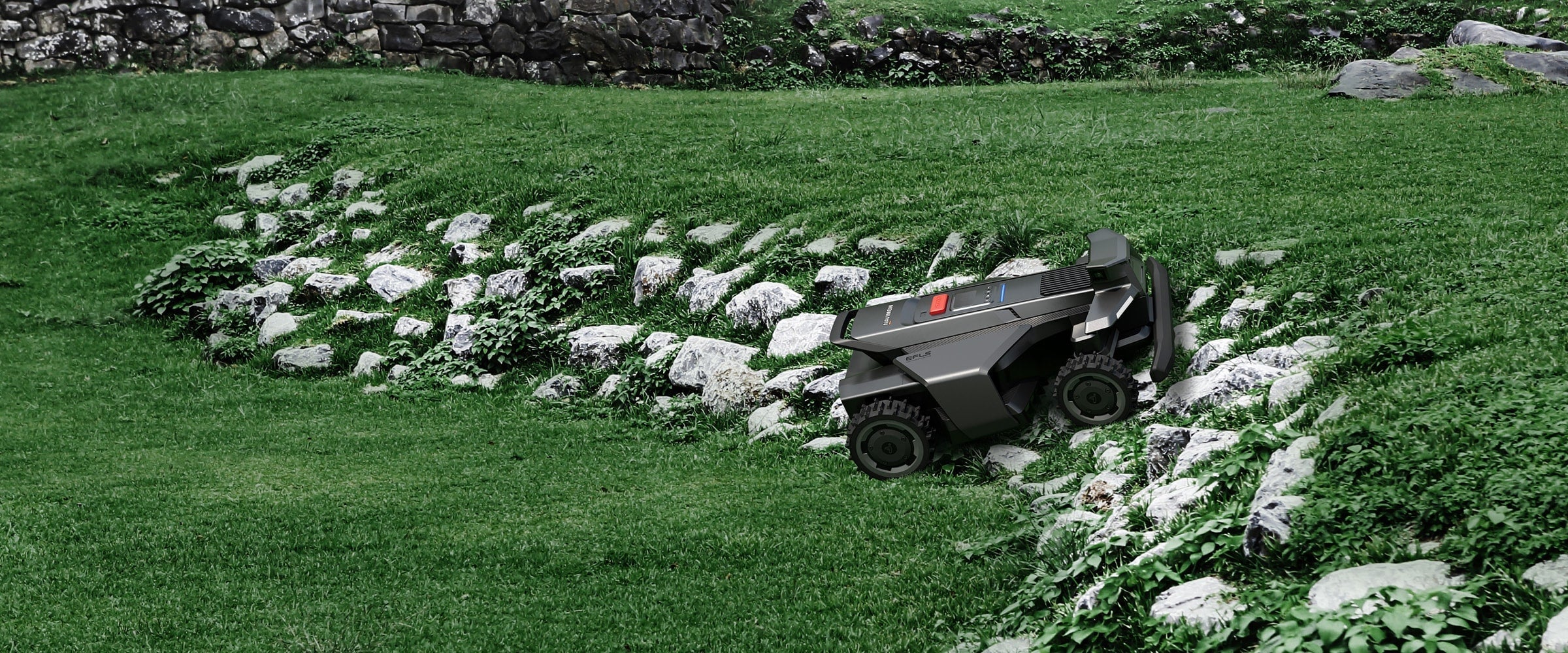 Navimow i110E robot lawn mower climbing over a rocky slope.