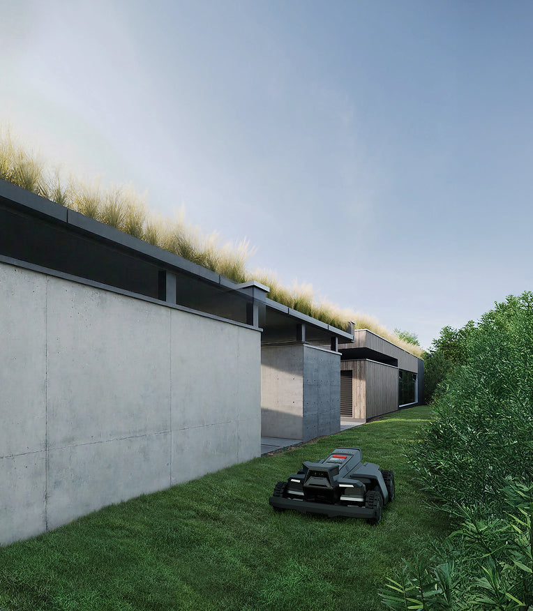 Navimow i105E robot lawn mower mows grass by modern building.