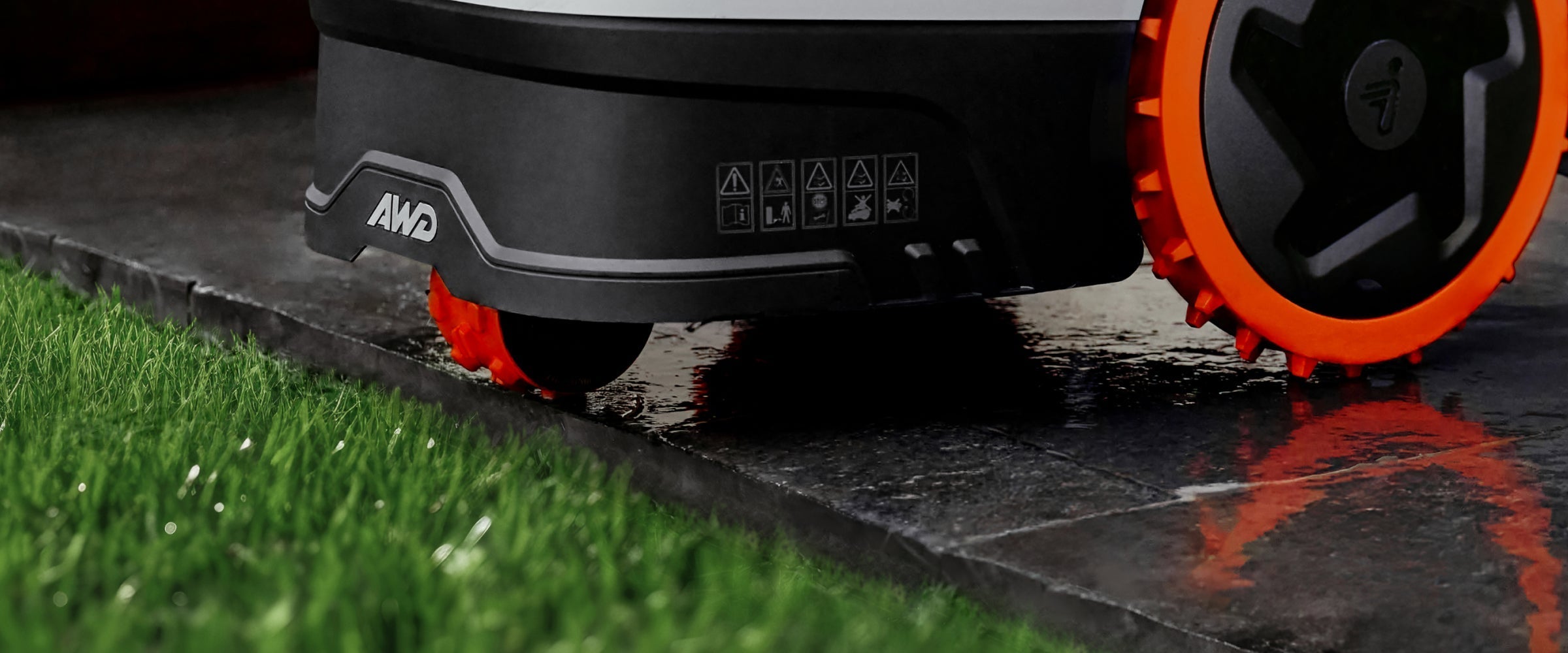 Navimow AWD robot lawn mower parked on a wet surface.