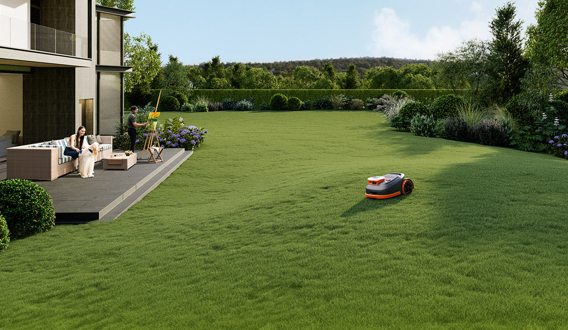 Navimow i110N robot lawn mower mows a large green yard.