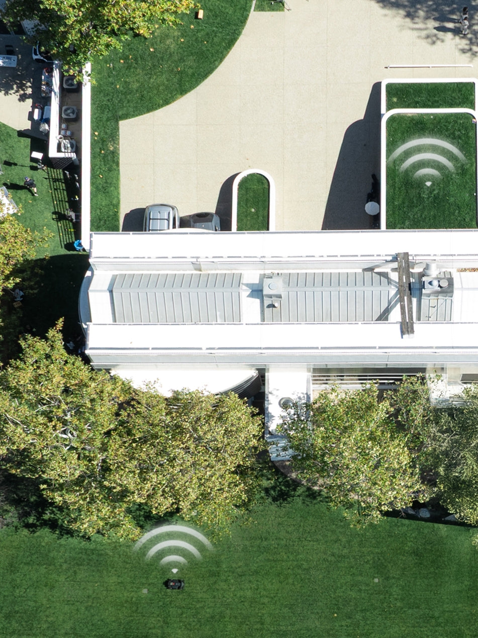 Segway Navimow i110E robot lawn mower mows this green yard.